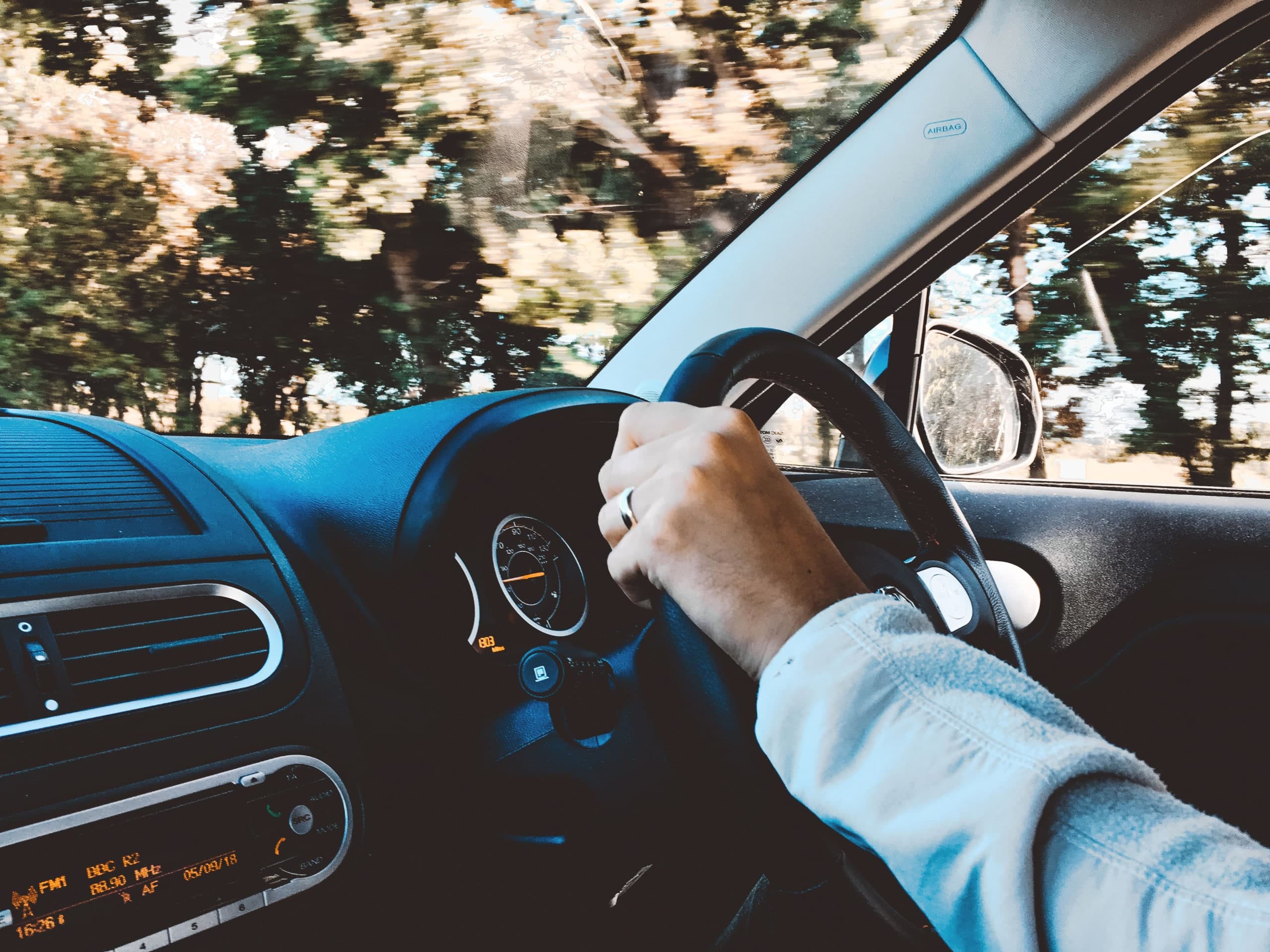 Driver's hands on the steering wheel